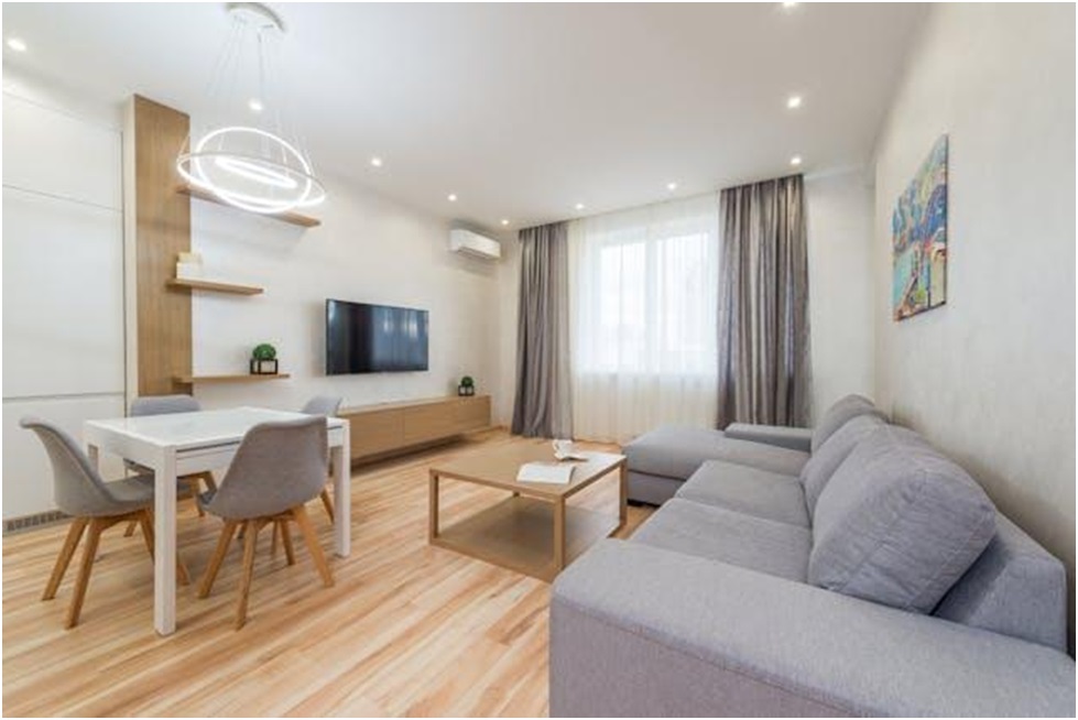 Living room with gray couch and dining set